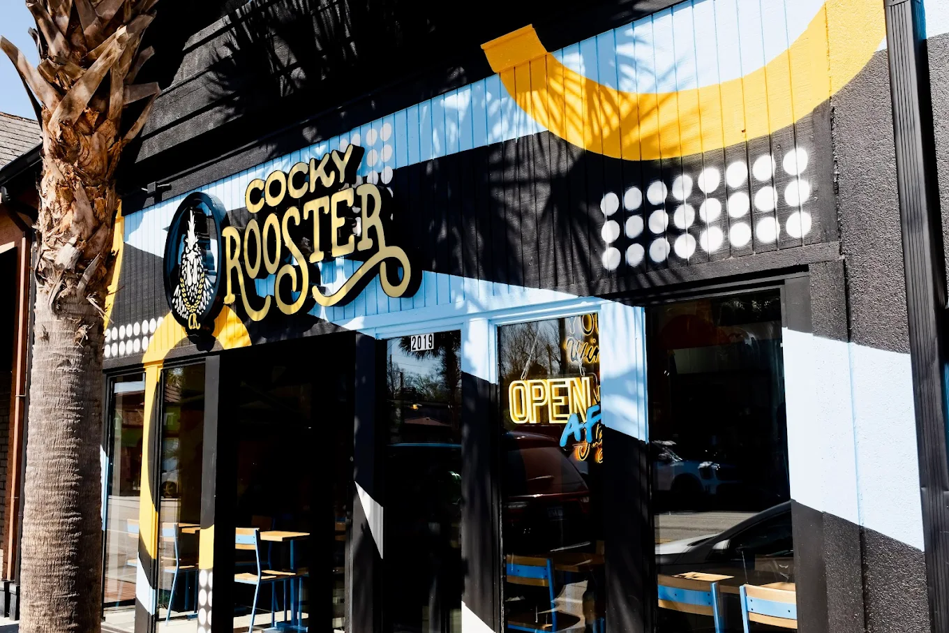 Front entrance of Cocky Rooster on Devine Street with the Open sign lit