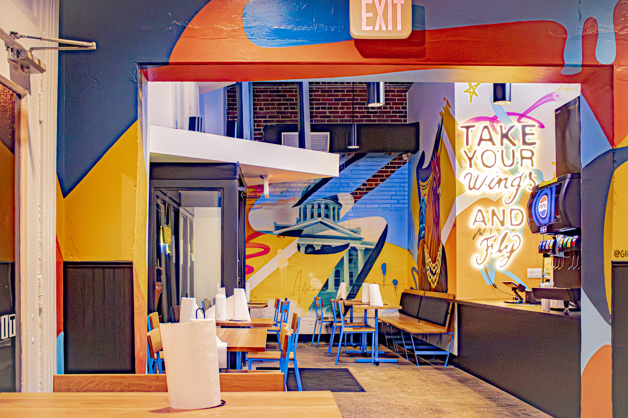 Take Your Wings and Fly wall art and colorful murals inside the Columbia dining room