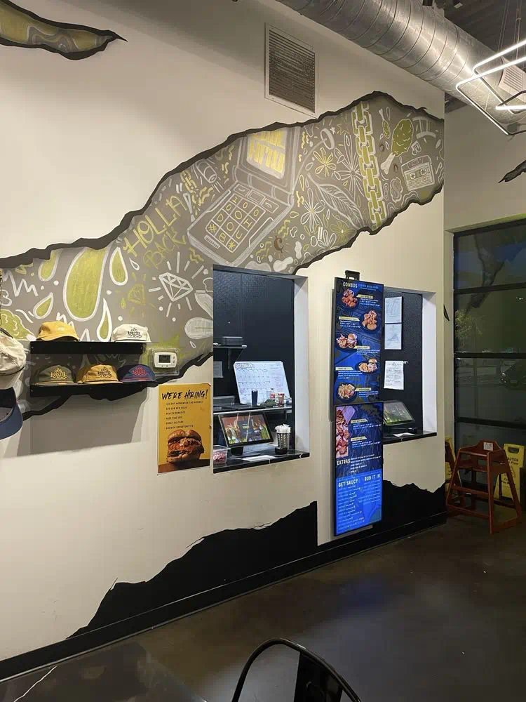 Menu boards and pickup shelf beside the order window