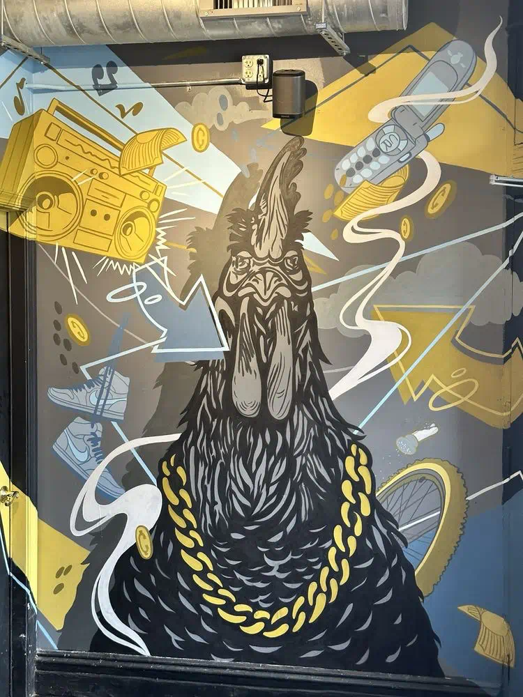 Black and gold rooster mural with a gold chain and boombox, Cocky Rooster The Fan dining room